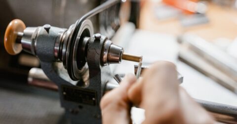 Industrial engineer checking bolt compatibility and thread pitch with calipers