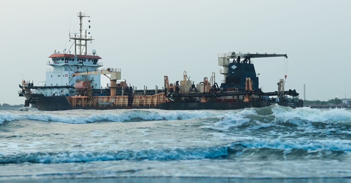 Large cargo ship navigating rough ocean waters showing structural steel joints